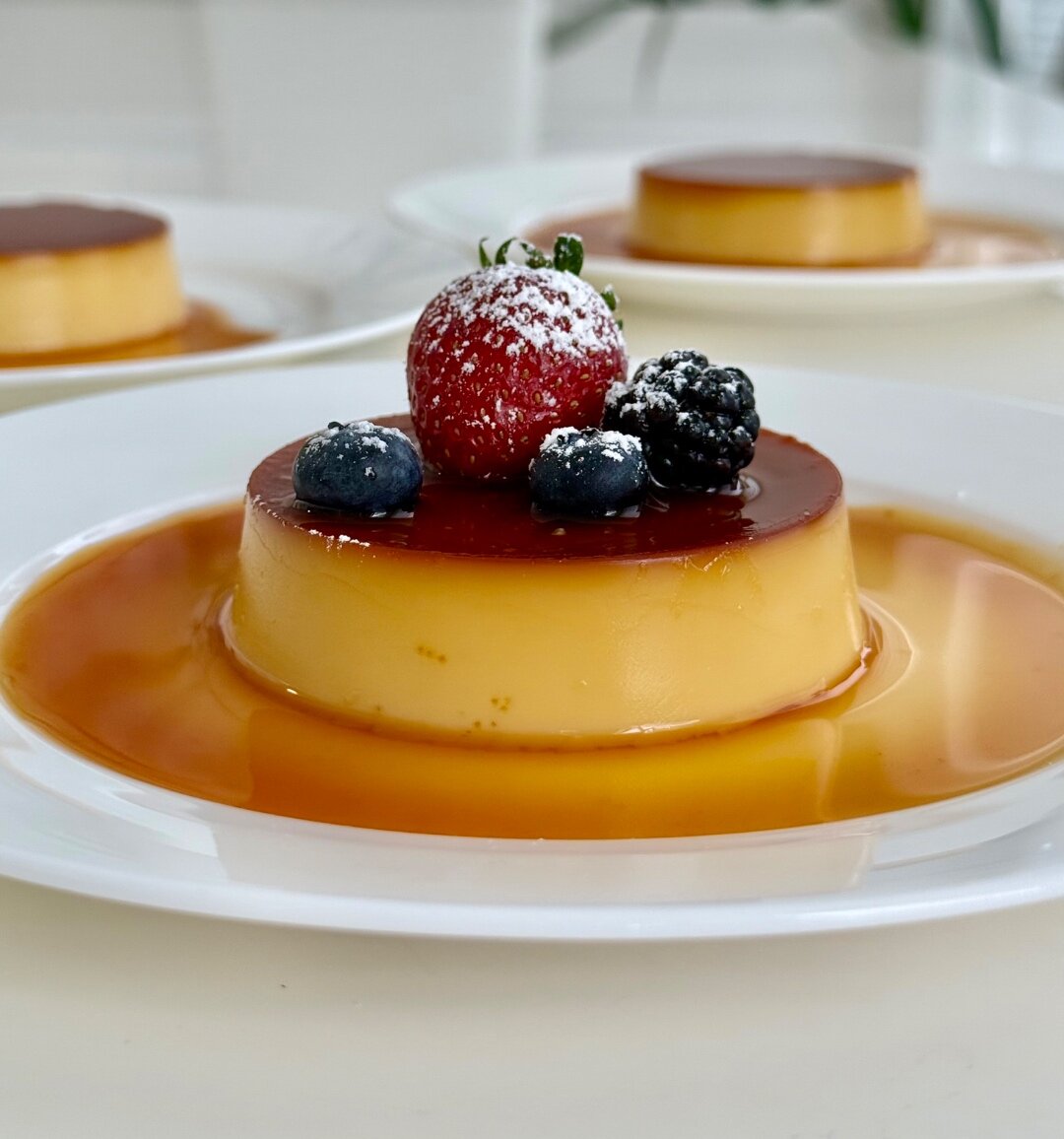 Leche flan topped with fresh berries