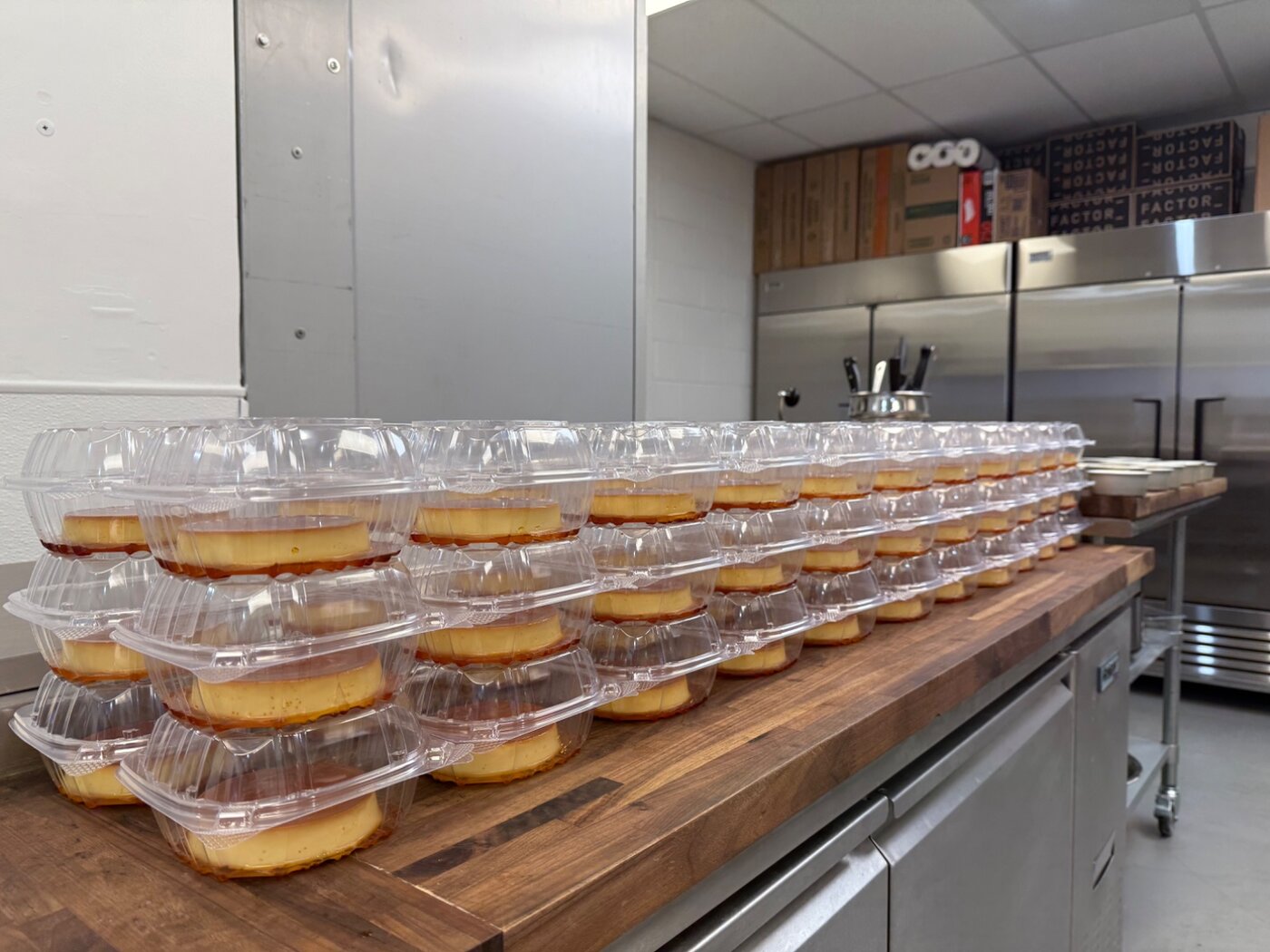 Rows of individual leche flan cups packaged for delivery